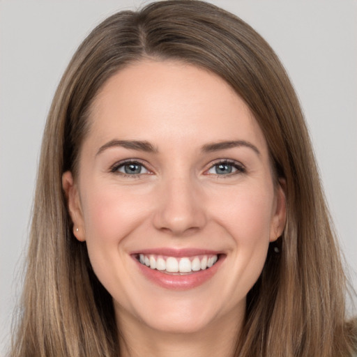 Joyful white young-adult female with long  brown hair and grey eyes