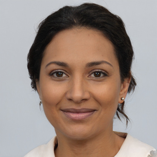 Joyful latino adult female with medium  brown hair and brown eyes