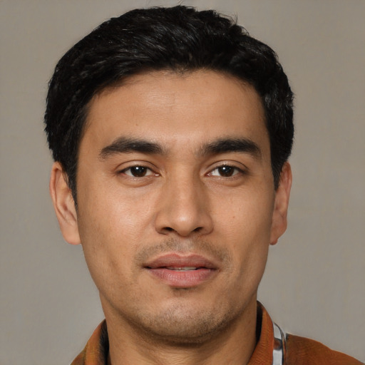 Joyful asian young-adult male with short  black hair and brown eyes