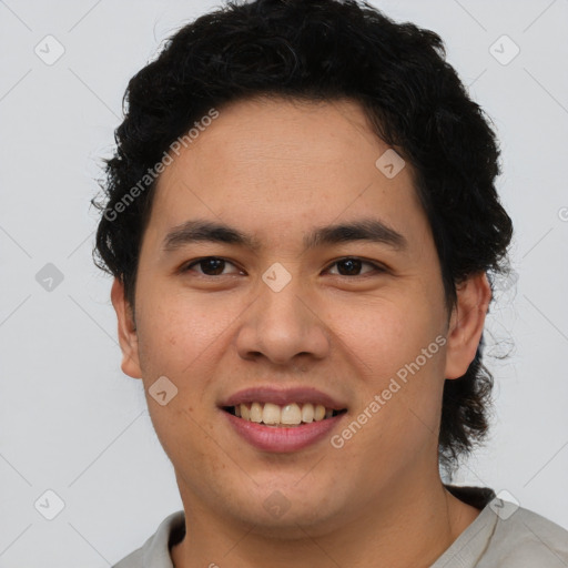 Joyful latino young-adult male with short  brown hair and brown eyes