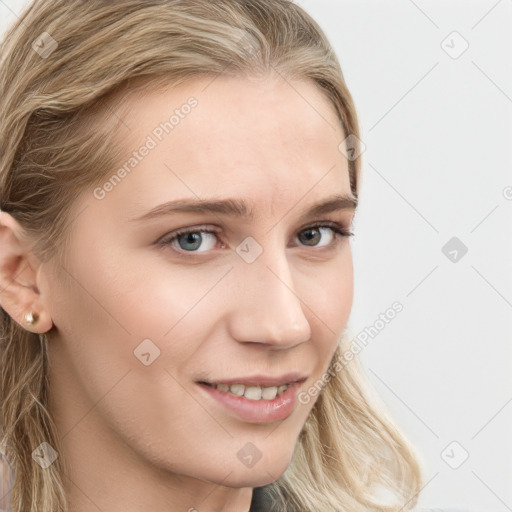 Joyful white young-adult female with long  brown hair and blue eyes