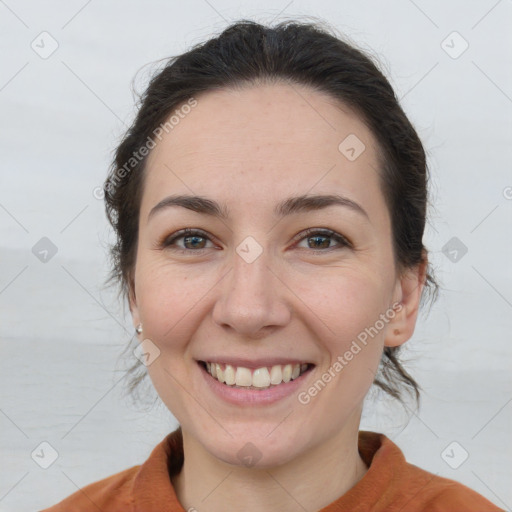 Joyful white adult female with medium  brown hair and brown eyes