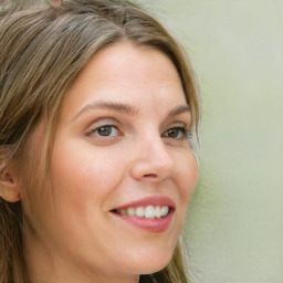 Joyful white young-adult female with long  brown hair and green eyes