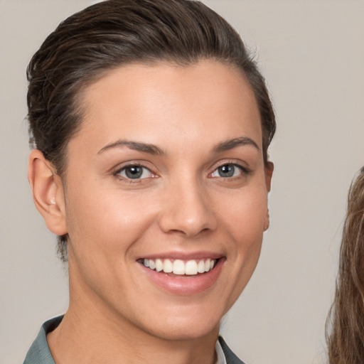 Joyful white young-adult female with short  brown hair and brown eyes