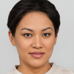 Joyful asian young-adult female with short  brown hair and brown eyes