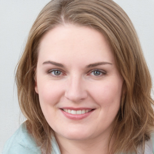 Joyful white young-adult female with medium  brown hair and blue eyes