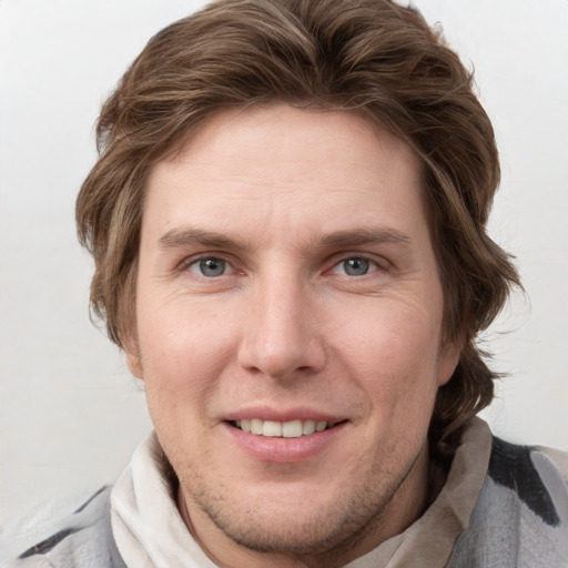 Joyful white adult male with short  brown hair and grey eyes