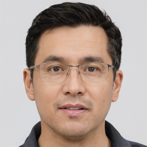 Joyful white adult male with short  black hair and brown eyes