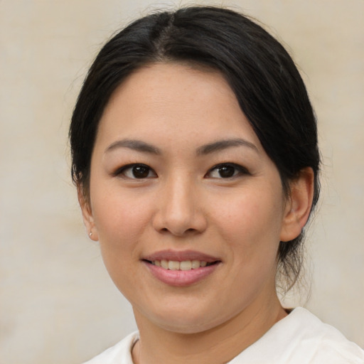 Joyful asian young-adult female with medium  brown hair and brown eyes