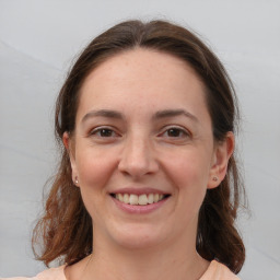 Joyful white young-adult female with medium  brown hair and grey eyes