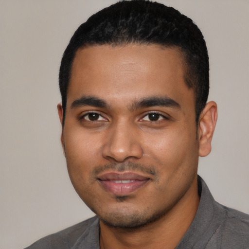 Joyful latino young-adult male with short  black hair and brown eyes