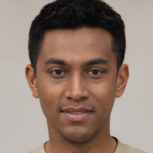 Joyful latino young-adult male with short  black hair and brown eyes