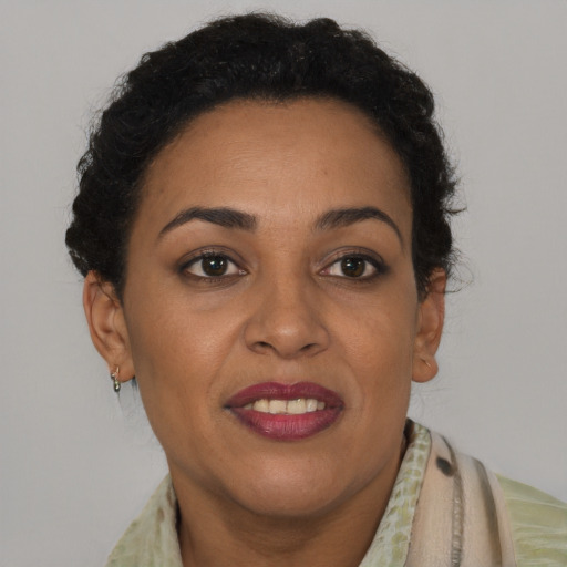Joyful latino adult female with short  brown hair and brown eyes