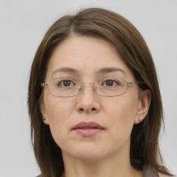 Joyful white adult female with long  brown hair and grey eyes