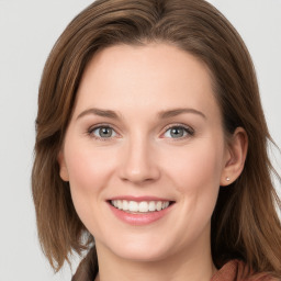 Joyful white young-adult female with long  brown hair and blue eyes