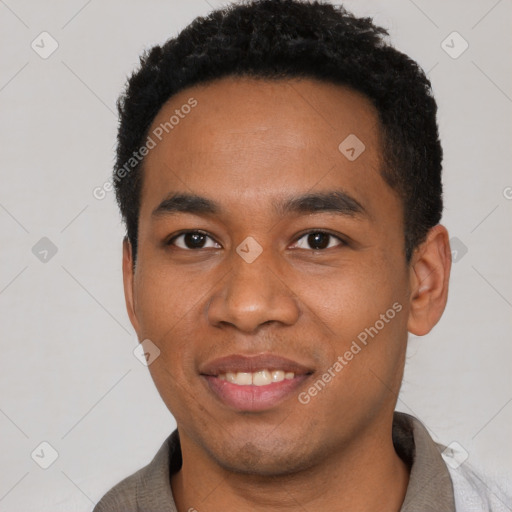 Joyful black young-adult male with short  black hair and brown eyes