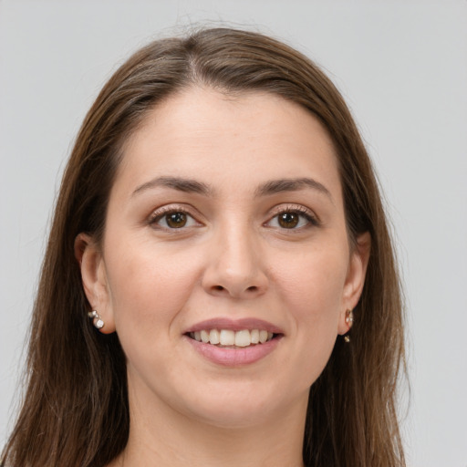 Joyful white young-adult female with long  brown hair and brown eyes