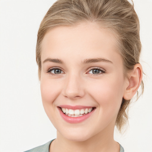 Joyful white young-adult female with medium  brown hair and blue eyes