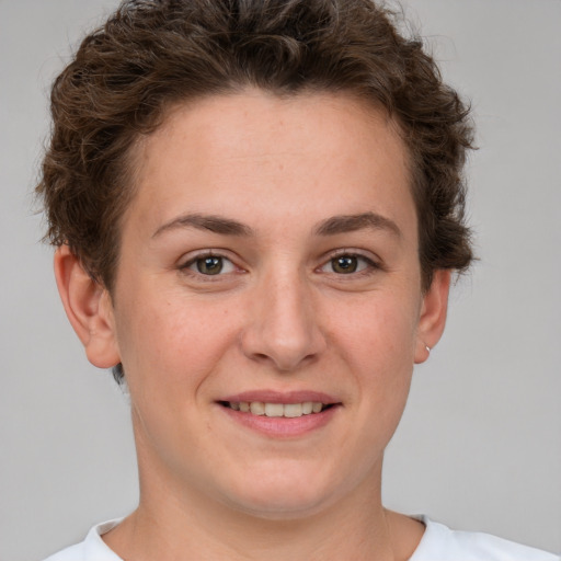 Joyful white young-adult female with short  brown hair and grey eyes