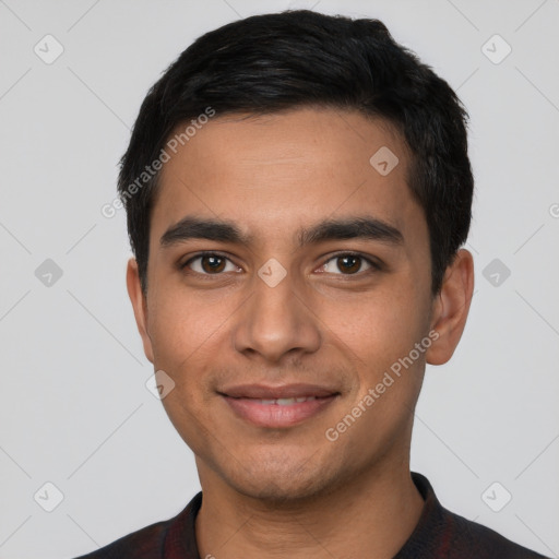 Joyful latino young-adult male with short  black hair and brown eyes