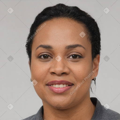 Joyful black young-adult female with short  black hair and brown eyes