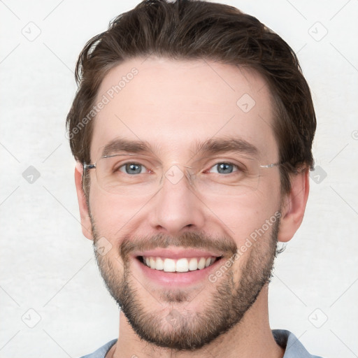 Joyful white young-adult male with short  brown hair and grey eyes