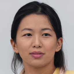 Joyful asian young-adult female with medium  brown hair and brown eyes