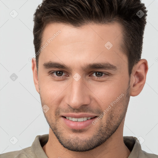 Joyful white young-adult male with short  brown hair and brown eyes