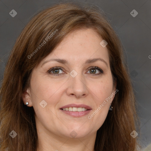 Joyful white adult female with long  brown hair and grey eyes