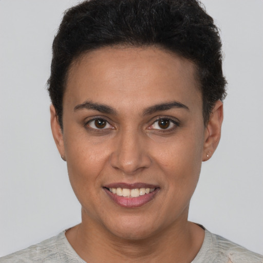 Joyful latino young-adult female with short  brown hair and brown eyes