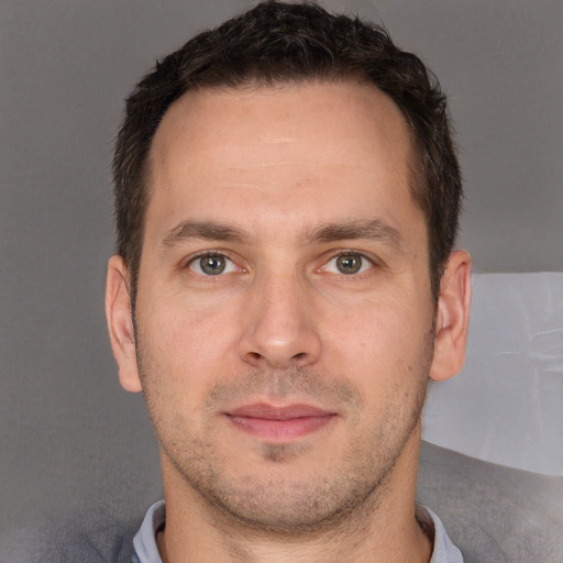 Joyful white adult male with short  brown hair and brown eyes