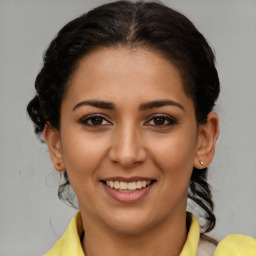 Joyful latino young-adult female with short  brown hair and brown eyes