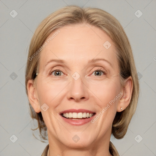 Joyful white adult female with medium  brown hair and grey eyes