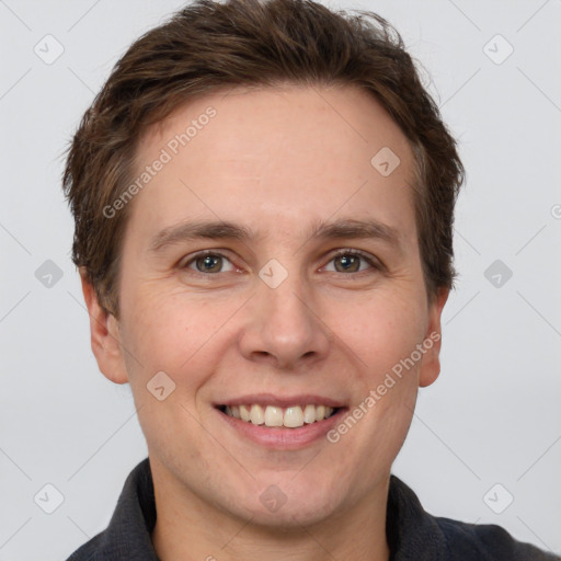 Joyful white adult male with short  brown hair and grey eyes