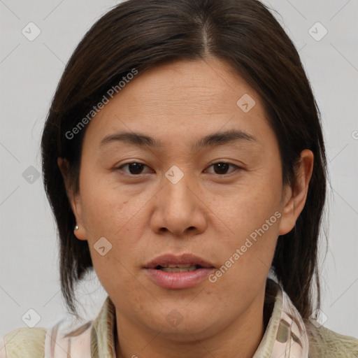 Joyful latino adult female with medium  brown hair and brown eyes