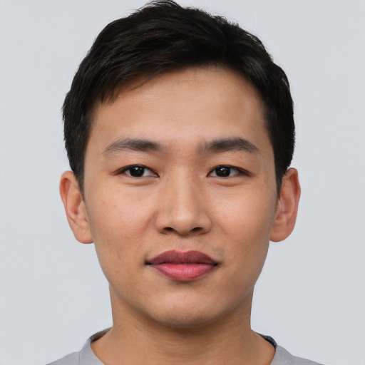 Joyful asian young-adult male with short  black hair and brown eyes