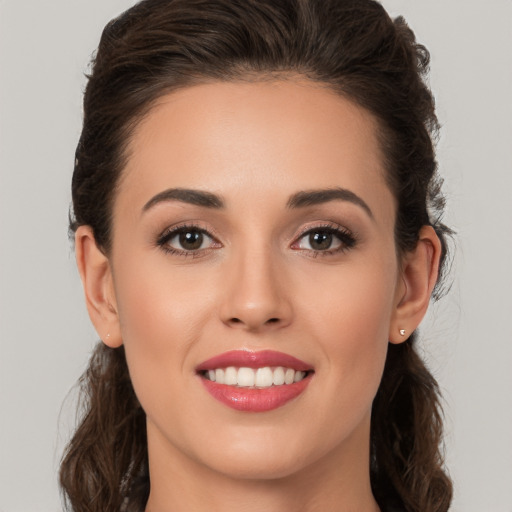 Joyful white young-adult female with long  brown hair and brown eyes