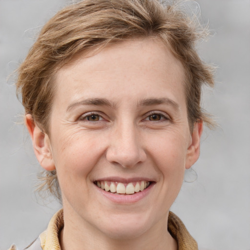 Joyful white adult female with medium  brown hair and grey eyes