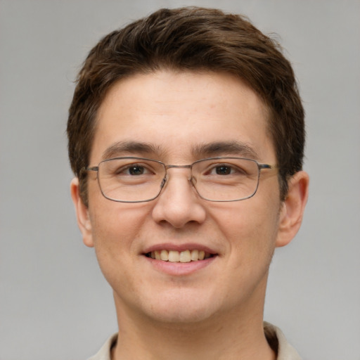 Joyful white young-adult male with short  brown hair and grey eyes
