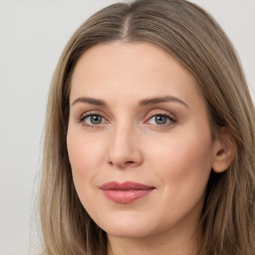 Joyful white young-adult female with long  brown hair and grey eyes