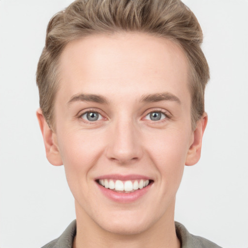 Joyful white young-adult female with short  brown hair and grey eyes