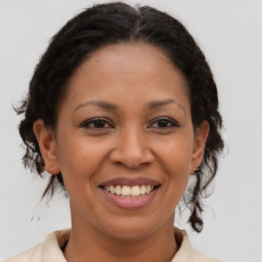 Joyful latino adult female with medium  brown hair and brown eyes