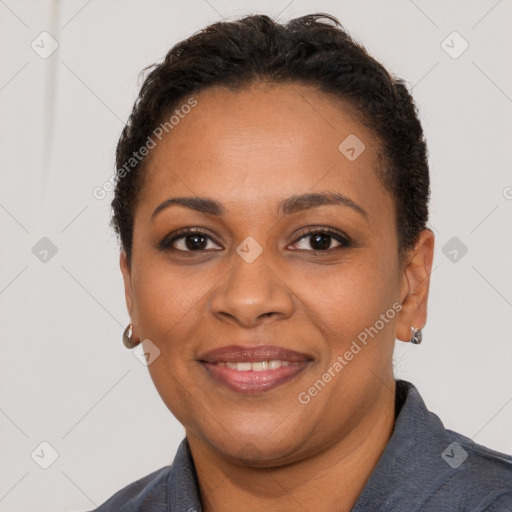 Joyful black adult female with short  brown hair and brown eyes