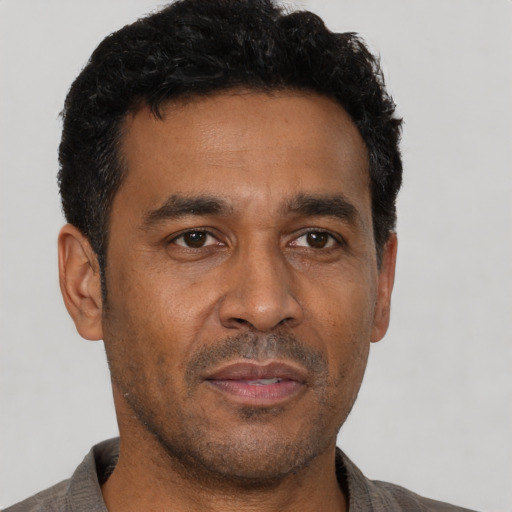 Neutral latino adult male with short  black hair and brown eyes