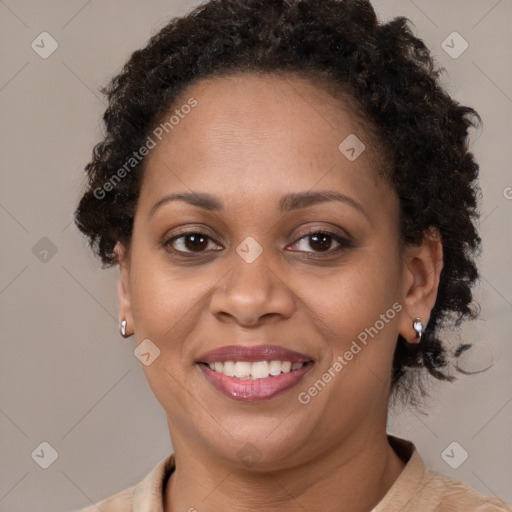 Joyful black adult female with short  brown hair and brown eyes