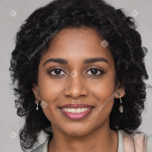 Joyful black young-adult female with long  black hair and brown eyes