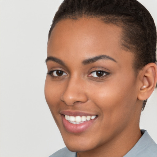 Joyful latino young-adult female with short  brown hair and brown eyes