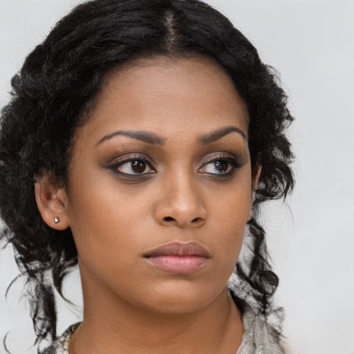 Neutral black young-adult female with long  brown hair and brown eyes