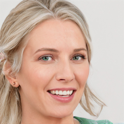 Joyful white young-adult female with long  blond hair and blue eyes