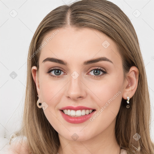 Joyful white young-adult female with long  brown hair and grey eyes